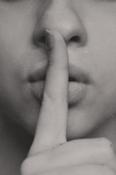 A woman with her finger over her lips