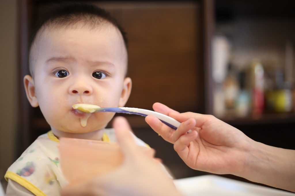 adorable baby preparing to eat baby food